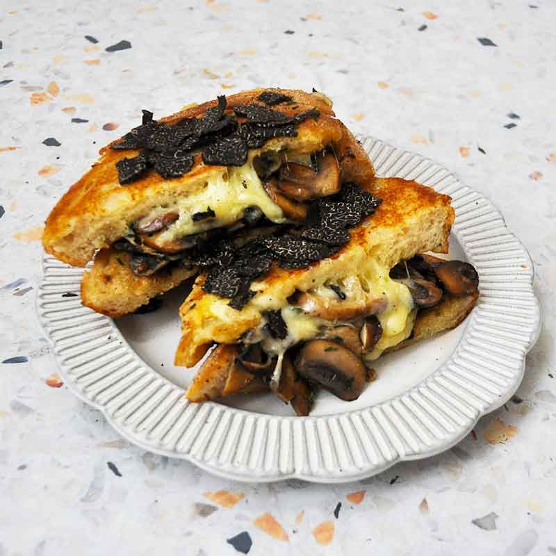 Mushroom and provolone cheese sourdough toastie with Shaved truffle